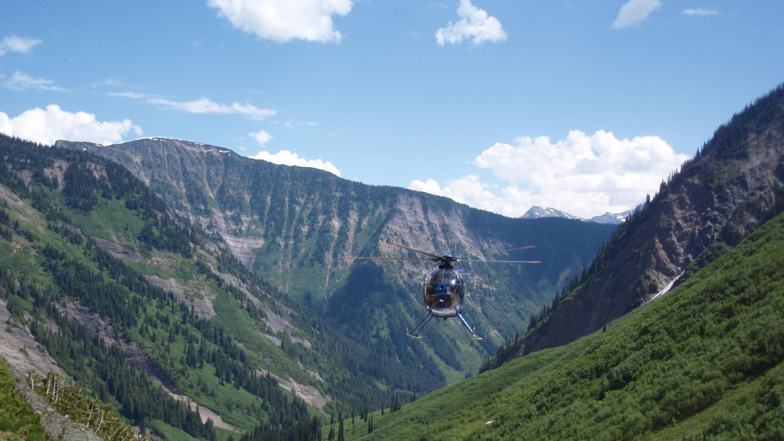 Helicopter approaching geology crew for pick up Helicopter arriving for geological crew pick up in the East Kootenays